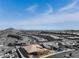 Aerial view showcasing the home, desert landscaping, and the city skyline in the distance at 3120 Greenscape Ln, Las Vegas, NV 89138