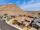 Aerial view of the home featuring a mountain backdrop and desert landscape at 3120 Greenscape Ln, Las Vegas, NV 89138