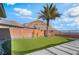 Beautiful backyard with putting green, palm tree, desert landscaping and mountain views at 3120 Greenscape Ln, Las Vegas, NV 89138