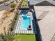 Aerial view of backyard featuring a modern pool, spa, putting green, and outdoor kitchen area at 3120 Greenscape Ln, Las Vegas, NV 89138
