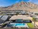 Stunning backyard with a refreshing pool, putting green, covered patio, and mountain views at 3120 Greenscape Ln, Las Vegas, NV 89138