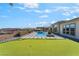 Gorgeous backyard with putting green, pool and lounge area at 3120 Greenscape Ln, Las Vegas, NV 89138