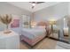 Bedroom features a plush bed with unique headboard, mirrored nightstand and natural light at 3120 Greenscape Ln, Las Vegas, NV 89138