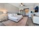 Stylish bedroom showcasing a modern accent wall, ceiling fan, and ensuite bathroom at 3120 Greenscape Ln, Las Vegas, NV 89138