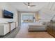 Large bedroom with TV, modern furnishings, and expansive windows with stunning mountain views at 3120 Greenscape Ln, Las Vegas, NV 89138