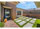Charming entry courtyard with decorative pavers, artificial turf, and desert landscaping at 3120 Greenscape Ln, Las Vegas, NV 89138