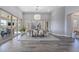 Elegant dining space with a modern chandelier, views of an outdoor patio, and contemporary design at 3120 Greenscape Ln, Las Vegas, NV 89138