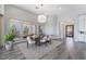 Bright dining room featuring contemporary lighting, neutral decor, and scenic backyard views at 3120 Greenscape Ln, Las Vegas, NV 89138