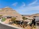 View of home featuring a desert landscape, mountain backdrop, and tile roof at 3120 Greenscape Ln, Las Vegas, NV 89138