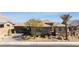 Front exterior of the home featuring desert landscaping, a tile roof, and a brick driveway at 3120 Greenscape Ln, Las Vegas, NV 89138