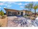 A single-story home featuring a desert landscape, brick driveway, and modern attached garage at 3120 Greenscape Ln, Las Vegas, NV 89138
