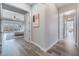 Hallway with wood-look tile flooring leading to a bedroom with mountain views through large windows at 3120 Greenscape Ln, Las Vegas, NV 89138