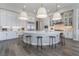 Contemporary kitchen featuring a center island with seating, sleek countertops, and stainless steel appliances at 3120 Greenscape Ln, Las Vegas, NV 89138