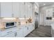 Bright kitchen featuring custom white cabinets, stainless steel appliances, and light countertops at 3120 Greenscape Ln, Las Vegas, NV 89138