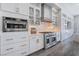 Bright kitchen featuring stainless steel appliances, white cabinets, and a subway tile backsplash at 3120 Greenscape Ln, Las Vegas, NV 89138