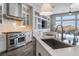 Kitchen with an island featuring a stainless steel dishwasher and views of the backyard and living spaces at 3120 Greenscape Ln, Las Vegas, NV 89138