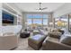 Bright living room featuring modern furniture, a ceiling fan, and expansive views of the outdoor landscape at 3120 Greenscape Ln, Las Vegas, NV 89138