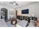 Inviting living room with stylish decor, ceiling fan, and views of the backyard at 3120 Greenscape Ln, Las Vegas, NV 89138