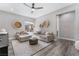 Cozy living room with comfortable seating, neutral decor, and wood-look flooring at 3120 Greenscape Ln, Las Vegas, NV 89138