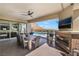 Outdoor dining area with a fireplace and mountain views overlooking the pool at 3120 Greenscape Ln, Las Vegas, NV 89138