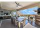 Covered outdoor dining area with fireplace, pool view, and access to living room at 3120 Greenscape Ln, Las Vegas, NV 89138