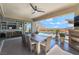 Covered outdoor dining area with fireplace, pool view, and access to living room at 3120 Greenscape Ln, Las Vegas, NV 89138