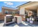 Outdoor kitchen features built-in grill and refrigerator, perfect for entertaining at 3120 Greenscape Ln, Las Vegas, NV 89138