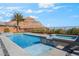 Inviting pool and spa area with a serene waterfall feature and desert mountain views at 3120 Greenscape Ln, Las Vegas, NV 89138