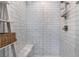 A modern walk-in shower with white subway tile, a built-in seat, and sleek fixtures at 3120 Greenscape Ln, Las Vegas, NV 89138