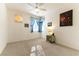 This spacious bedroom features a ceiling fan, neutral carpet, and bright, natural light at 3215 Stratford Hall Ct, Las Vegas, NV 89135