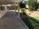 A covered patio with a view of the landscaped backyard featuring gravel, bushes, and an artificial lawn at 331 Mount Hope St, Henderson, NV 89014