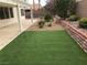 Backyard features an artificial lawn, privacy wall, and rock landscaping at 331 Mount Hope St, Henderson, NV 89014