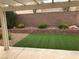 Backyard features an artificial lawn, rock landscaping, and covered patio at 331 Mount Hope St, Henderson, NV 89014