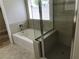 Bright bathroom features a separate tub and tiled shower with glass door at 331 Mount Hope St, Henderson, NV 89014