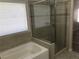 Bright bathroom features a separate tub and tiled shower with glass door at 331 Mount Hope St, Henderson, NV 89014