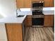 Modern kitchen with white quartz countertops, wooden cabinetry, and stainless steel appliances at 331 Mount Hope St, Henderson, NV 89014