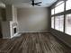 Bright living room boasting wood-look floors, fireplace, ceiling fan, and large windows at 331 Mount Hope St, Henderson, NV 89014