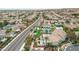 Aerial view of community with clubhouse, pool, putting green and homes with tile roofs at 3441 Mountain Park St, Las Vegas, NV 89129