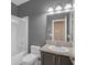 Well-lit bathroom features a granite countertop, framed mirror, and shower-tub combination at 3441 Mountain Park St, Las Vegas, NV 89129