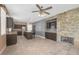 Inviting living space featuring a stone accent wall with a fireplace, tile flooring, kitchen view and recessed lighting at 3441 Mountain Park St, Las Vegas, NV 89129