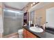Bathroom features single sink with granite countertop and tiled shower with glass doors at 3536 Golden Pedal St, Las Vegas, NV 89129