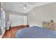 Bedroom featuring wood floors, a ceiling fan, and closet with mirrored doors at 3536 Golden Pedal St, Las Vegas, NV 89129