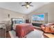 Cozy bedroom with a large window, ceiling fan, and comfortable furniture at 3536 Golden Pedal St, Las Vegas, NV 89129