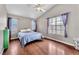 Bright bedroom with wood floors, ceiling fan, and a large window with lots of light at 3536 Golden Pedal St, Las Vegas, NV 89129