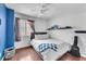 Bedroom featuring hard wood floors, ceiling fan, window and blue accents at 3536 Golden Pedal St, Las Vegas, NV 89129