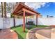 Backyard cabana featuring lounge seating, string lights, and decorative landscape at 3536 Golden Pedal St, Las Vegas, NV 89129