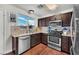 Modern kitchen featuring stainless steel appliances, granite countertops, and ample natural light at 3536 Golden Pedal St, Las Vegas, NV 89129