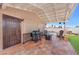 Covered patio with tile flooring, grill, and comfortable seating area at 3536 Golden Pedal St, Las Vegas, NV 89129
