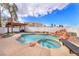 Sparkling pool and spa surrounded by lush landscaping and lounge areas at 3536 Golden Pedal St, Las Vegas, NV 89129