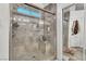 Luxurious walk-in shower featuring a glass door, bench, and modern fixtures at 3536 Golden Pedal St, Las Vegas, NV 89129